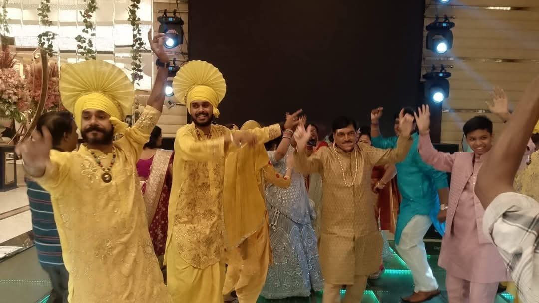 Choreographed grand entry production with performers lining a decorated wedding walkway