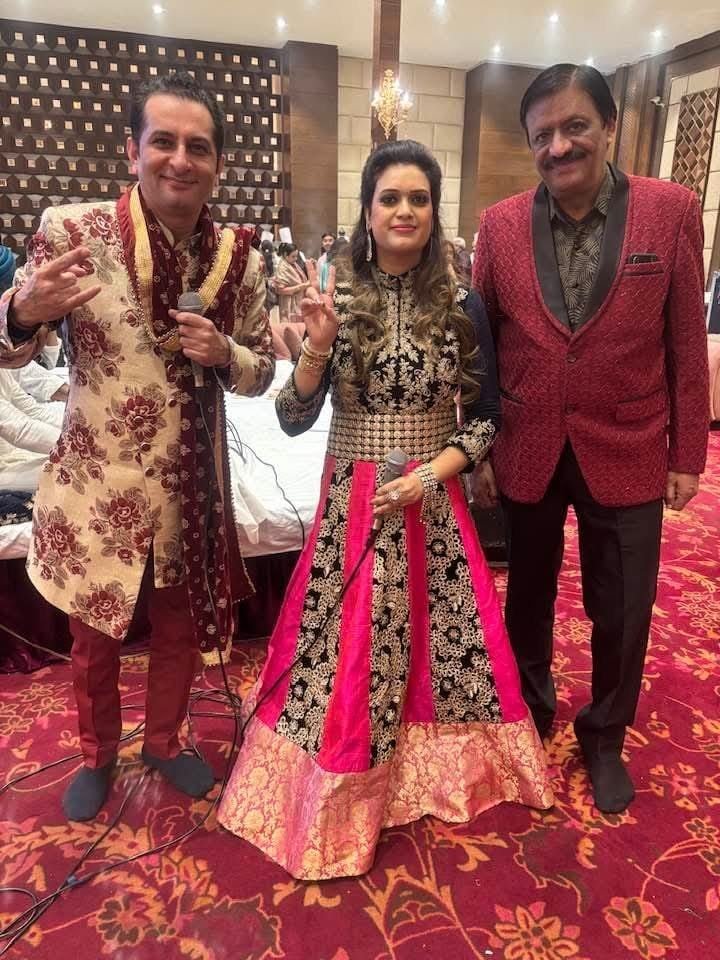 Rajesh Bajaj of Star Musical Entertainer with a singer and anchor at a wedding celebration